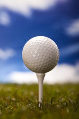 Golf ball on green meadow