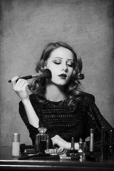 Woman applying cosmetics