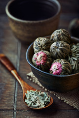 White tea balls and dried lemon grass in a dish