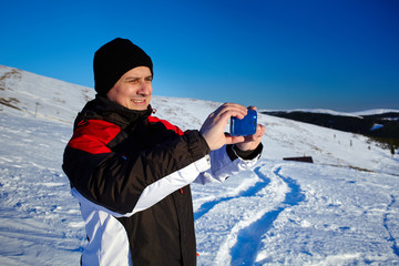 Fototapeta na wymiar Tourist shooting the landscape with mobile phone