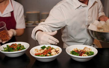Obraz na płótnie Canvas Chef is serving plates