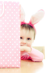 Fototapeta premium The little girl with pink ears bunny and bag.