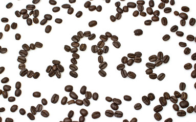The word of coffee is made of coffee beans is isolated on a whit