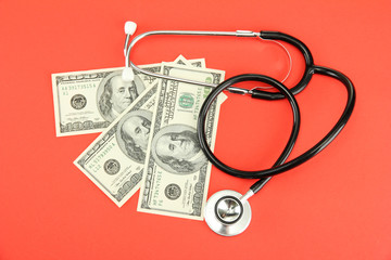 Healthcare cost concept: stethoscope and dollars