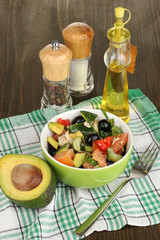 Tasty avocado salad in bowl   surrounded by spices