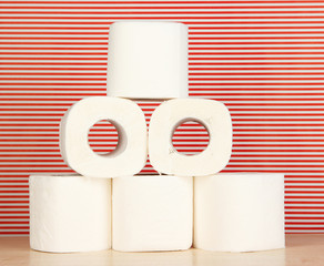 Rolls of toilet paper on striped red background