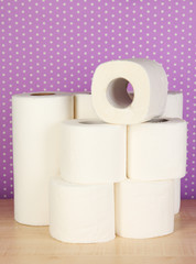 Rolls of toilet paper on purple with dots background