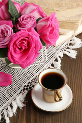 Beautiful pink roses in vase on wooden table close-up