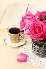 Beautiful pink roses in vase on wooden table close-up