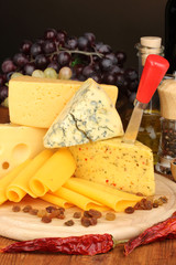 Various types of cheese on wooden board