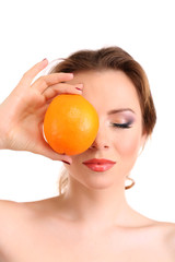Beautiful young woman with bright make-up, holding orange,