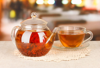 Exotic green tea with flowers in glass teapot