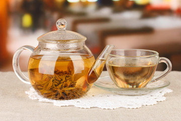 Exotic green tea with flowers in glass teapot