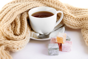 cup of tea with scarf isolated on white