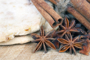 Fototapeta na wymiar Cinnamon , anise and bread on wooden table