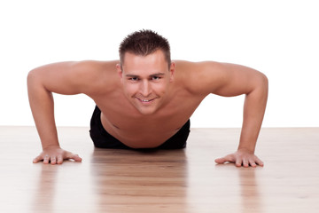 Handsome young man doing press ups - 48482076