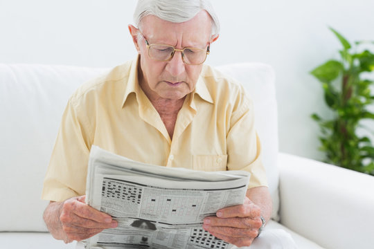Focused aged man reading the news