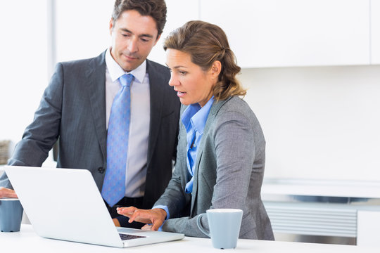 Couple using laptop before work