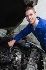 Fototapeta na wymiar Young mechanic repairing car engine
