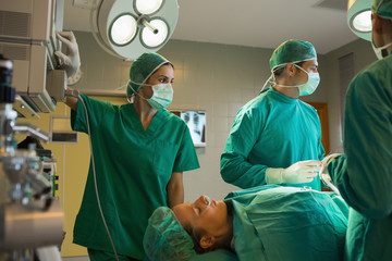 Surgeons working on a female patient