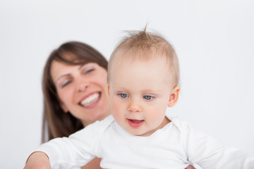 Happy mother holding her cute baby