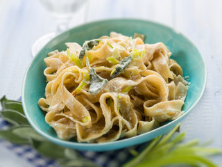 tagliatelle with leek sage and cream sauce, selective focus