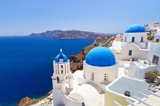 Fototapeta Blue and white church of Oia village on Santorini island. Greece