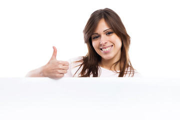 Fototapeta premium Portrait of a young woman with blank billboard