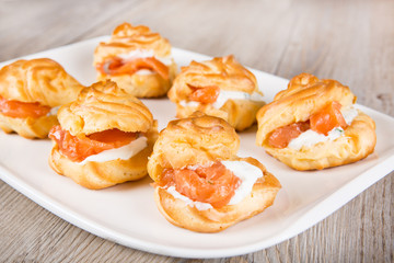 Eclairs and profiteroles filled with cream and salmon