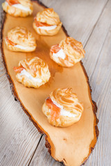 Eclairs and profiteroles filled with cream and salmon