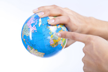 woman's hands holding a globe