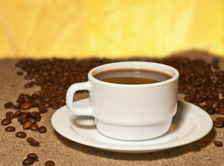 A cup of coffee on burlap on the table