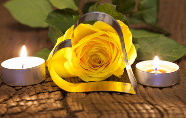 Yellow rose and candles