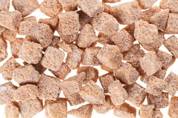 Many brown lump cane sugar cubes , food background