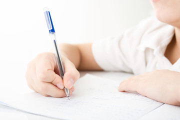 Child hands writing a homework