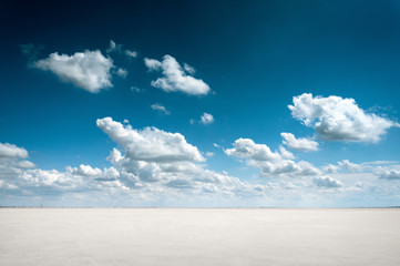 desert landscape with deep blue sky and clouds