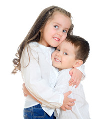 Little girl and boy hugging. Isolated on white