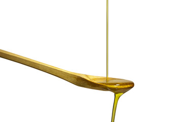Olive oil flowing over the wooden spoon