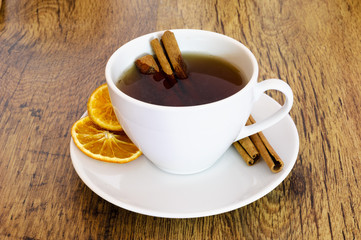 Cup of orange tea with cinnamon