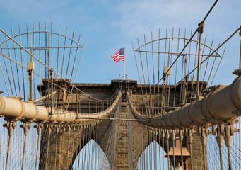 Brooklyn Bridge with US flag in New York City