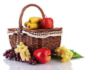 Picnic basket with fruits isolated on white