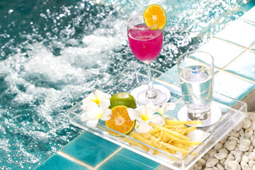 cocktail decorated with orange by the Jacuzzi pool