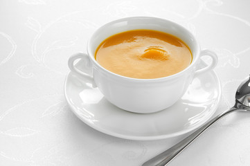 Close-up of roasted-pumpkin soup in a white bowl.