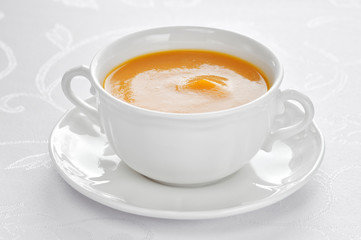 Close-up of roasted-pumpkin soup in a white bowl.