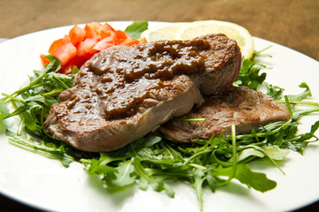 filetto di carne su letto di rucola e salsa all'aceto balsamico