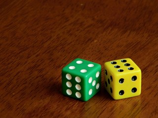 Two dices on wooden background