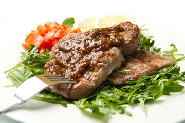 fresh grilled red meat with vegetables and sauce