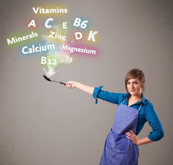 Young woman cooking vitamins and minerals