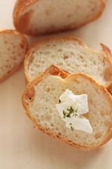 sliced french bread baguette with cream cheese on top