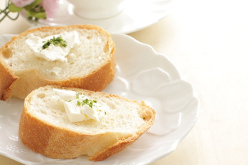 sliced french bread baguette with cream cheese on top